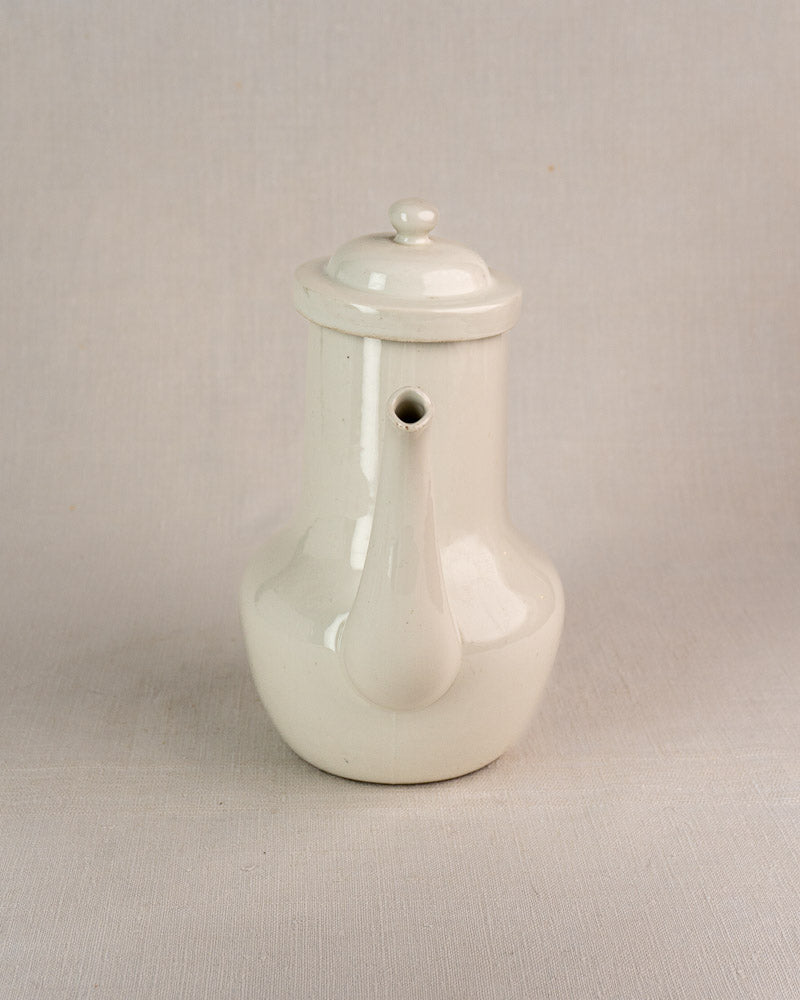 Early 20th-century French Limoges Frugier porcelian coffee pot with rounded white body and short spout.
