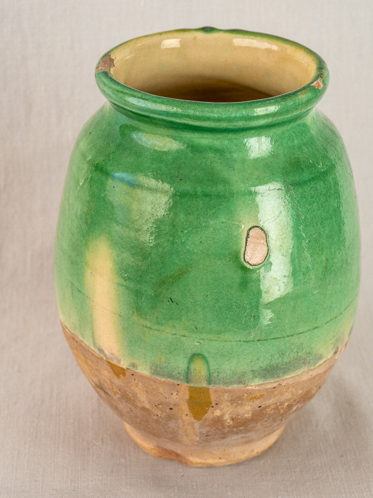 Antique French confit pot, terracotta with glossy green glaze, unglazed brown base, and worn vintage patina.