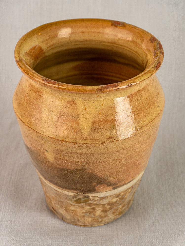 Antique French confit pot in yellow glazed terracotta with wide mouth, rounded body, glossy finish, and natural color variations.