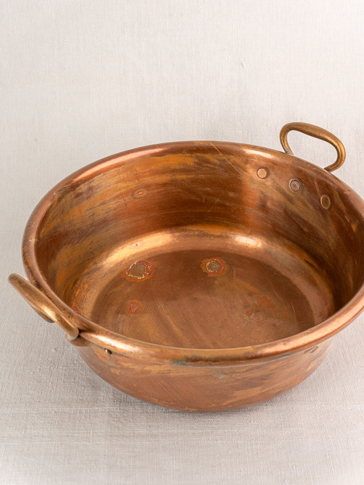 Pair of late 19th-century French copper basins with handles, vintage patina and tarnish, nesting set for Provence kitchen decor.
