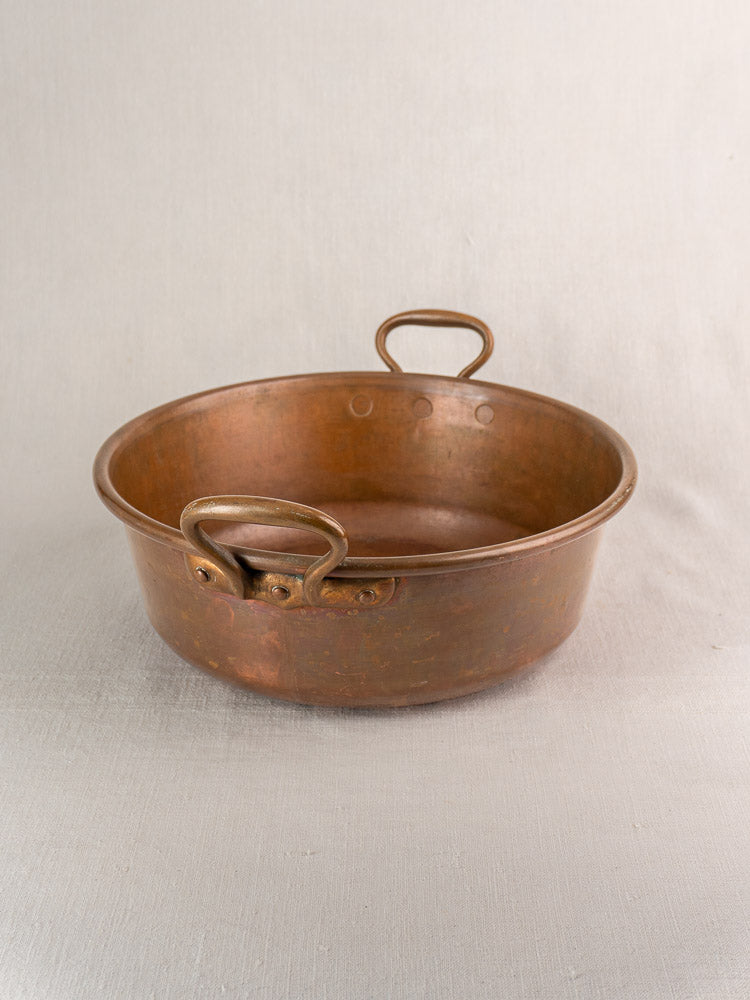 Pair of late 19th century antique French copper basins with brass handles and round, shallow form.