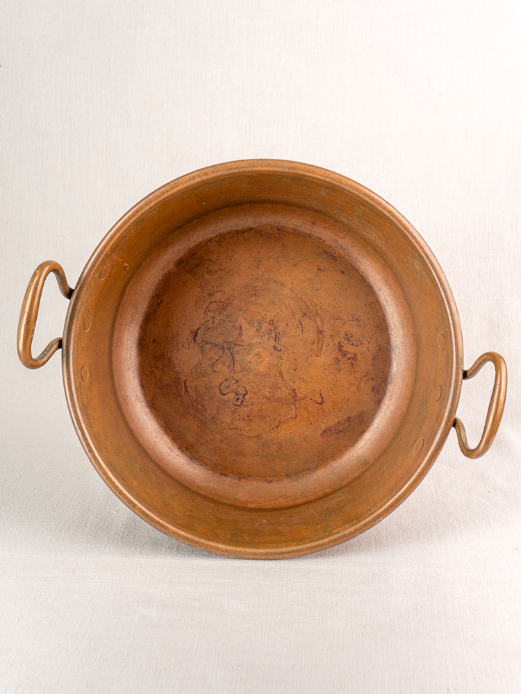 Pair of antique French copper basins with dual handles and aged patina, perfect vintage kitchen decor.