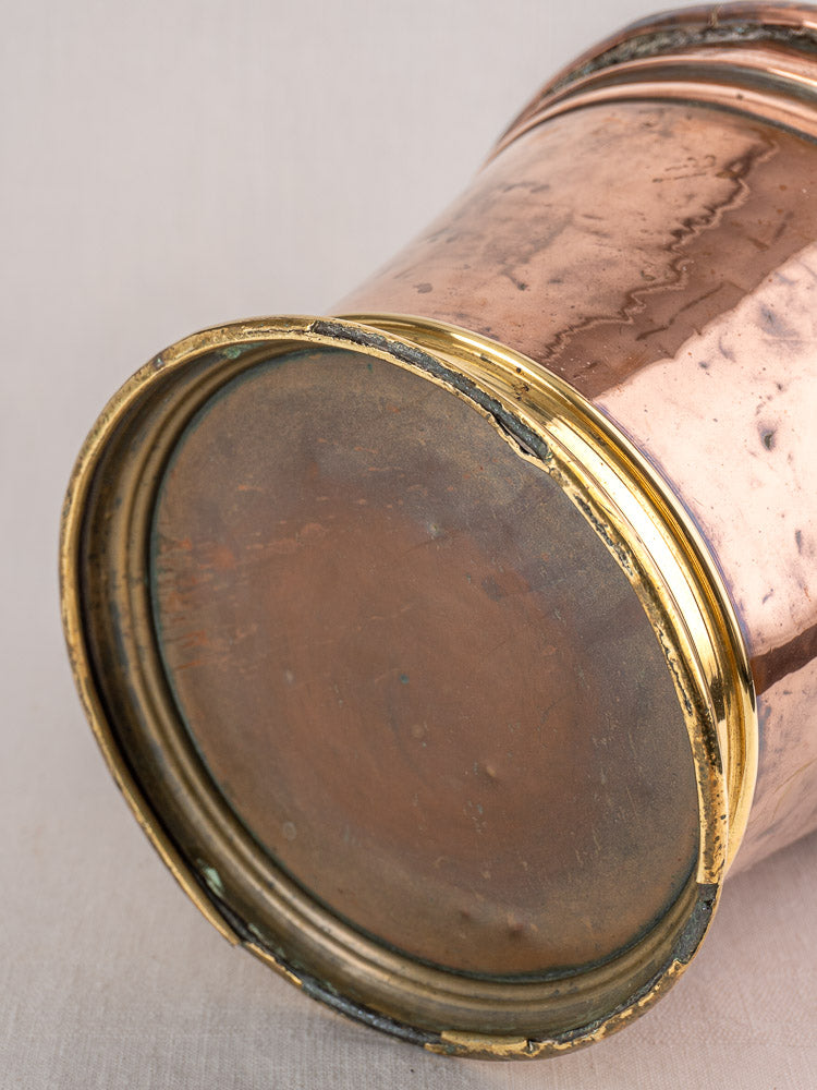 Antique French copper champagne bucket with brass rim and aged patina, late 19th century, rustic elegance.
