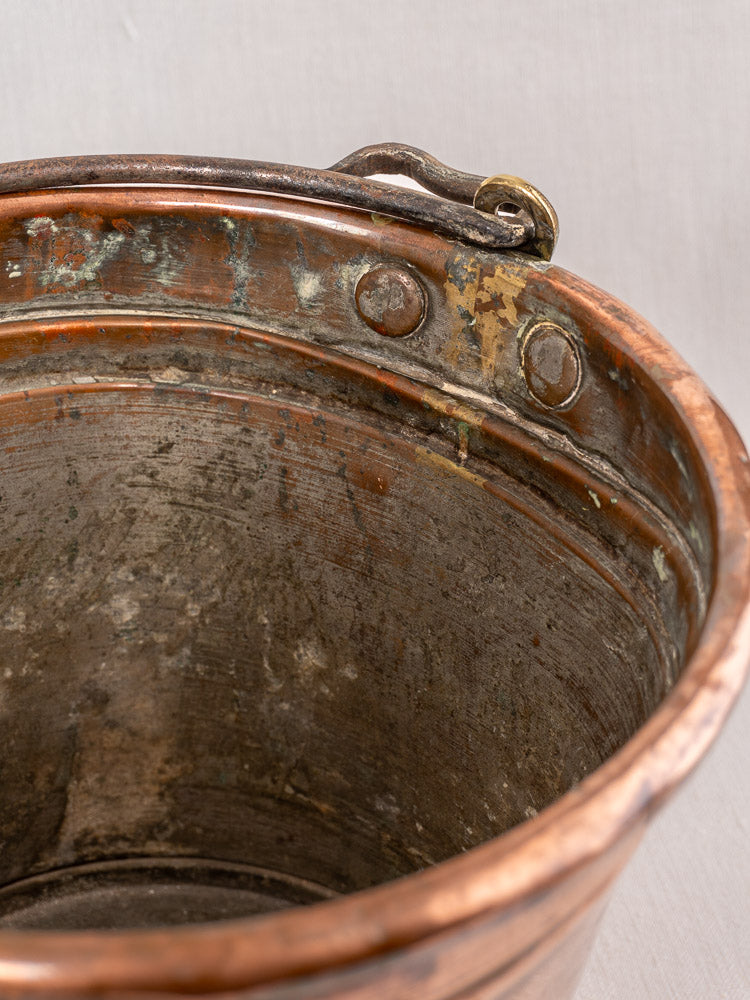 Antique French copper champagne bucket, late 19th century, with riveted handle, aged patina, and vintage character.