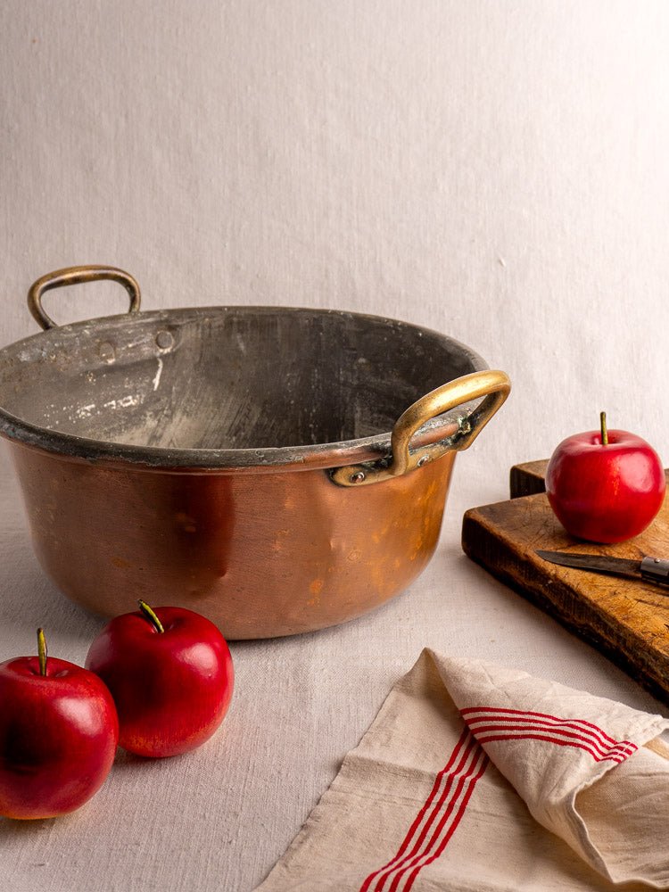 Antique French copper jam pan with brass handles, late 19th century, styled in kitchen setting.