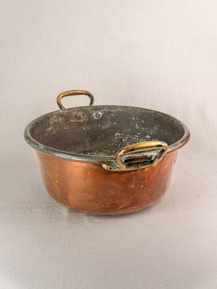 Antique French copper jam pan with brass handles, late 19th century, on a light background.