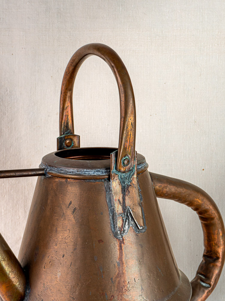 Vintage French copper watering can by Jean Goardère, with curved handle and aged patina.