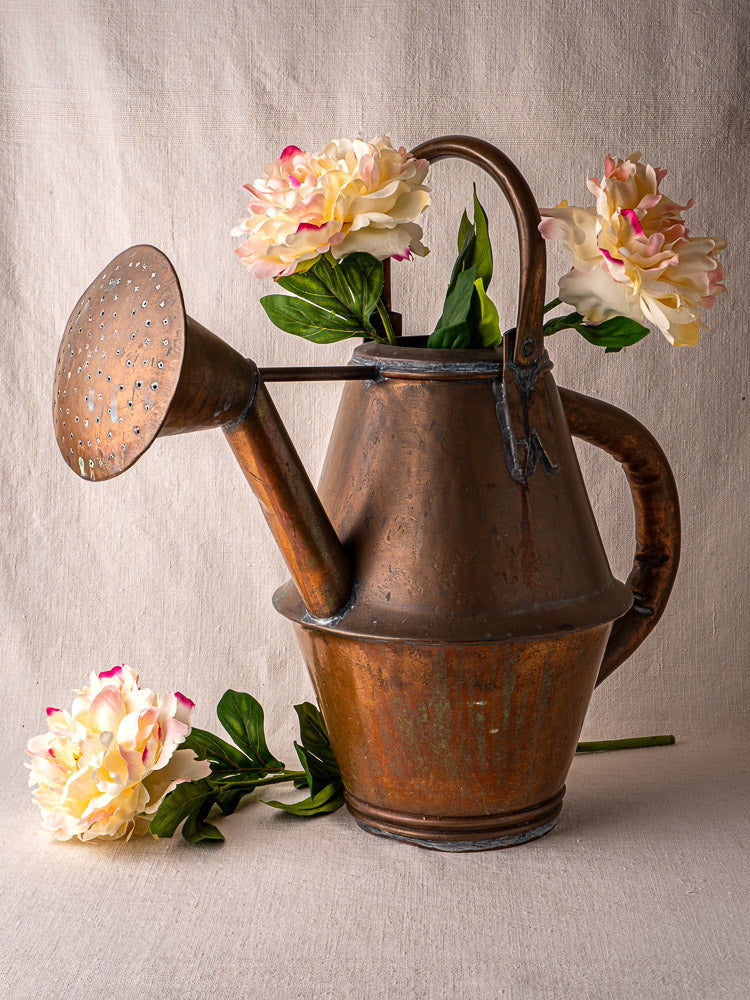 Vintage French copper watering can by Jean Goardère, Villedieu MOF, with pale pink peonies.