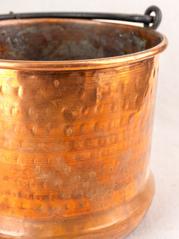 Pair of 19th-century French copper hanging cauldrons with rounded rims, weathered patina, and black metal handles.