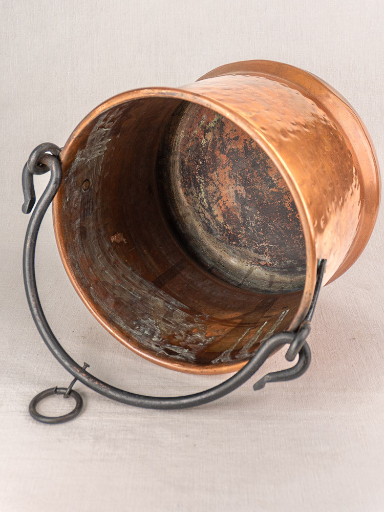 Pair of 19th-century French copper hanging buckets with black metal handles and worn interiors, perfect for vintage kitchen display.