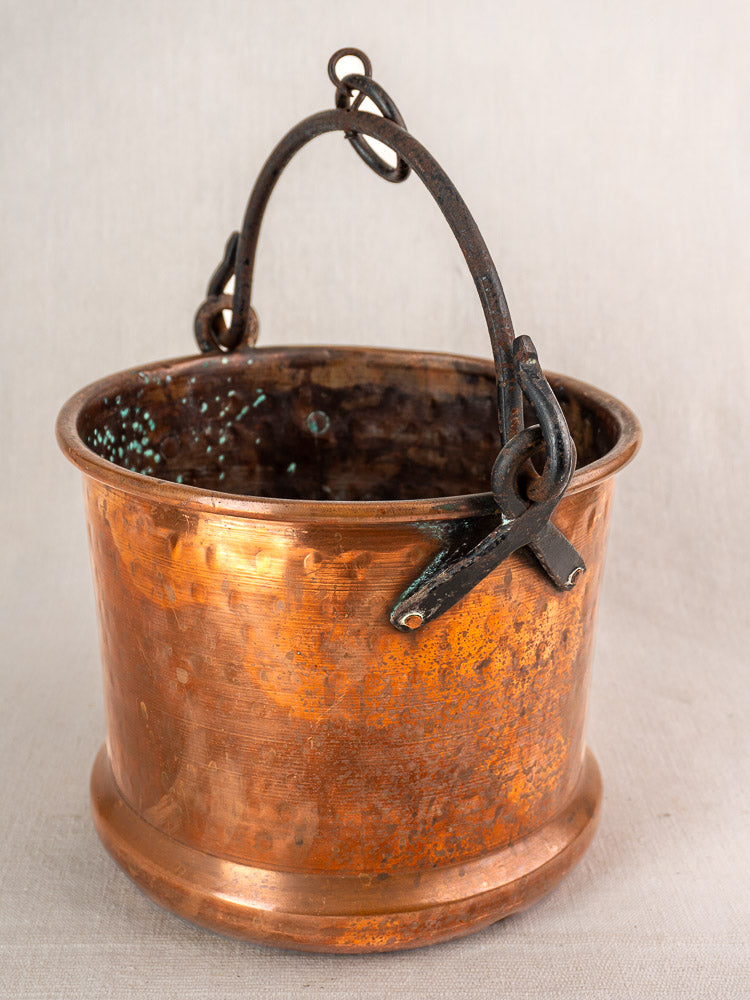 Pair of 19th-century French copper hanging buckets with dark metal handles, tarnished finish, and green patina.