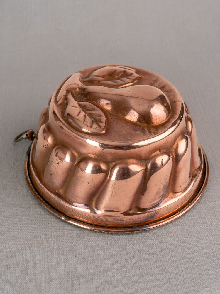 Antique French copper jelly mold with embossed pear and leaf design, 19th century vintage kitchen decor.