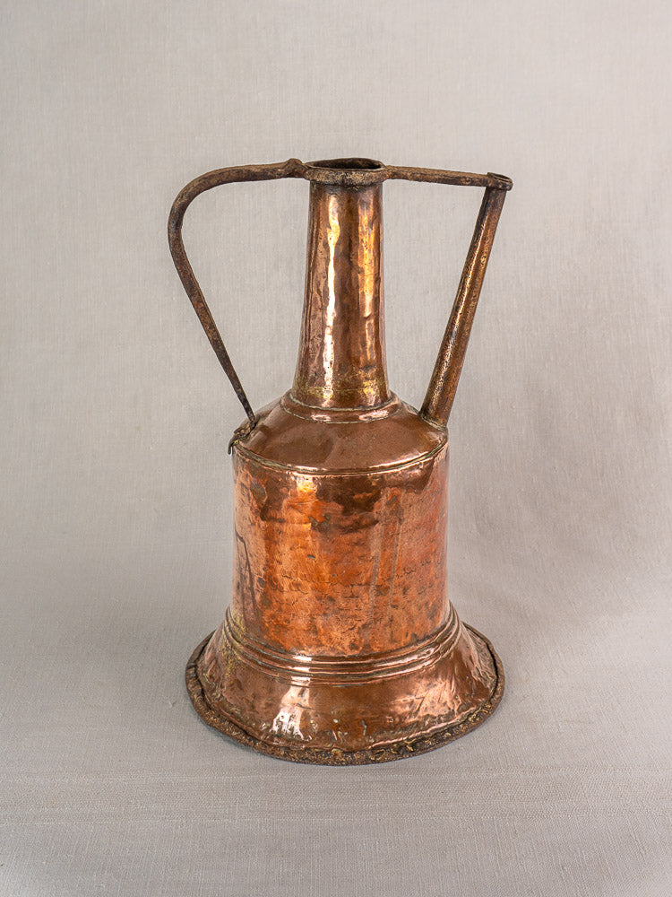 19th-century French hammered copper water jar with twin iron handles, displayed on a neutral surface.