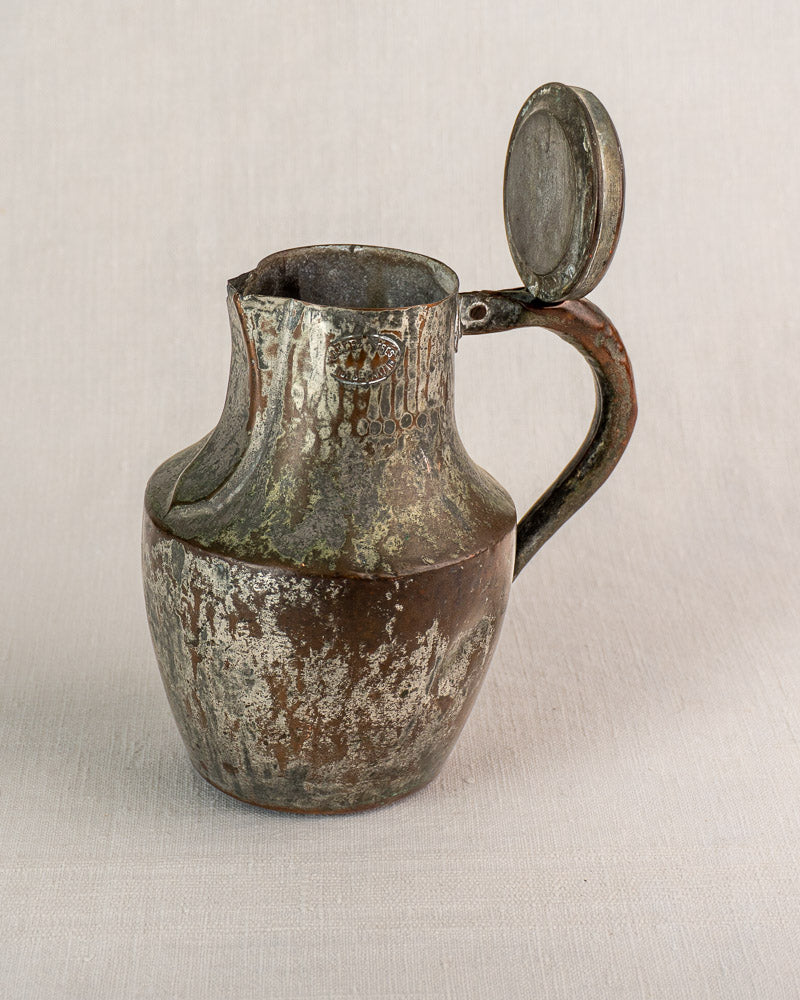 Antique French copper coquemar pitcher by Allez Frères Paris with hinged lid and handle, on fabric.