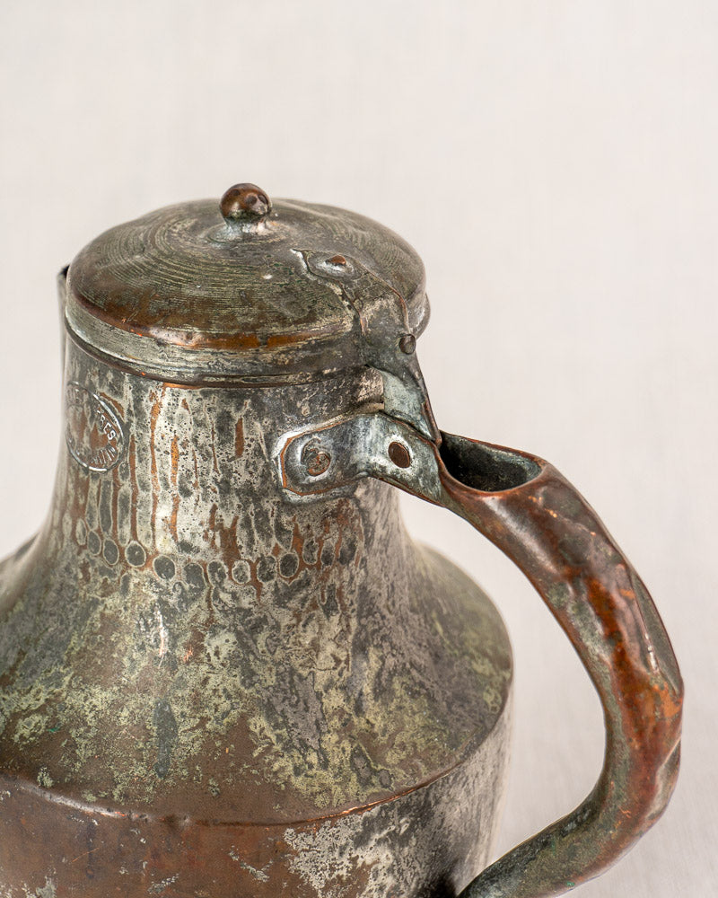 Antique French copper pitcher by Allez Frères Paris with hinged lid, patina, and green oxidation.