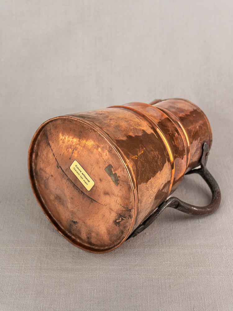 19th-century French copper measure jug with forged iron handle, hand-hammered details, and aged patina.
