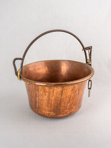 Antique French copper hearth pot petit chaudron with arched iron bail handle, gray background.