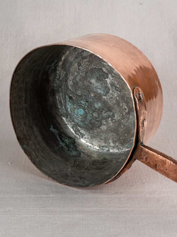 18th-century French antique copper preserving pot with solid handle, worn oxidized interior, and hand-forged rivets.