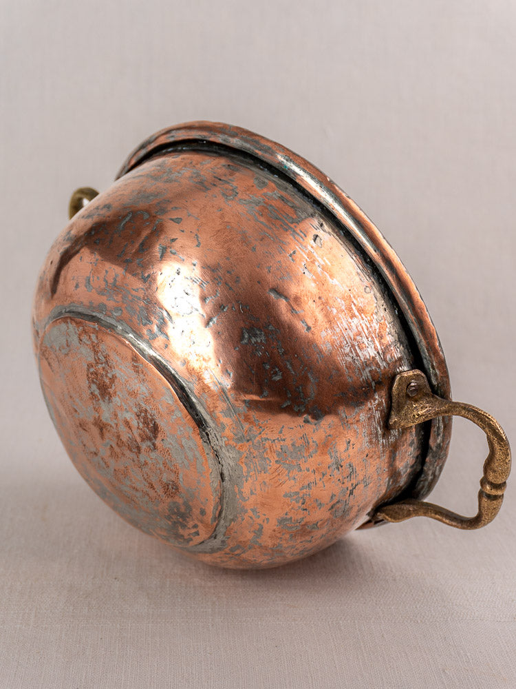 Antique French copper bowl with brass handles and lid, early 19th century, showing patina and wear.
