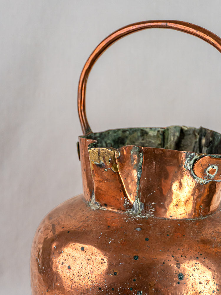 French antique copper water jug with double spouts, curved handle, and greenish oxidized rim.