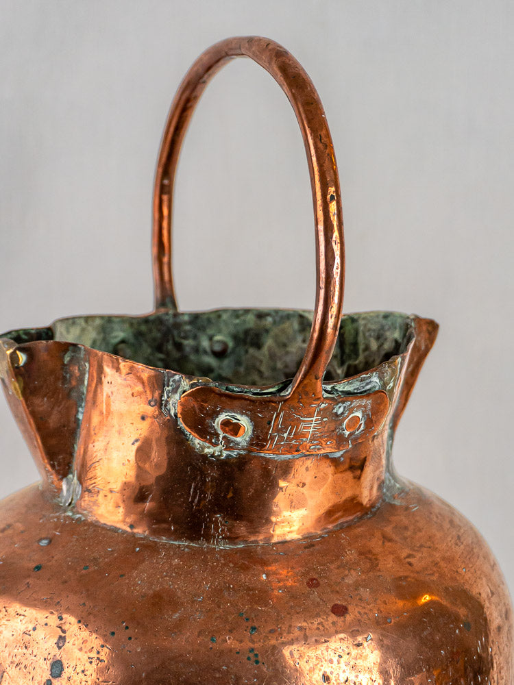 Antique French hand-raised copper water jug with double spout, curved handle, tarnish and patina.