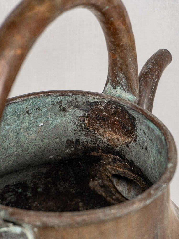 Antique French copper water jug, 19th century, hand-worked with rust and green patina on rim.