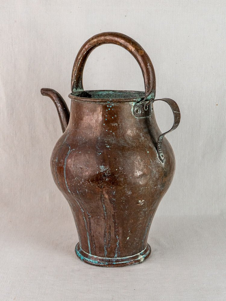Antique French copper water jug with curved handle and spout, shown on a plain background.
