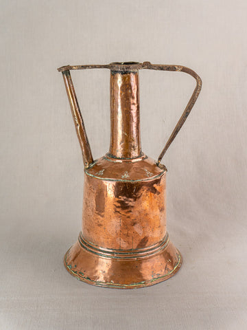 Antique French hand-hammered copper water jug with wide base, tall neck, side spout, iron handle on light background.