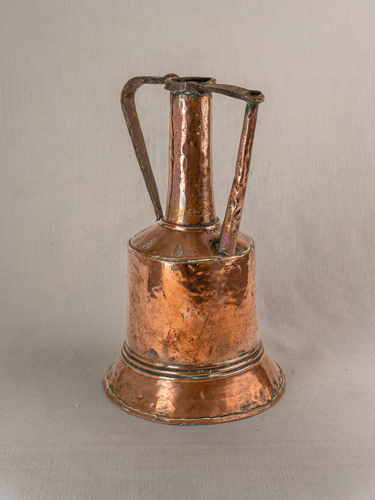 Antique French copper water jug with iron handles, hand-hammered, wide base, narrow neck, on a plain background.