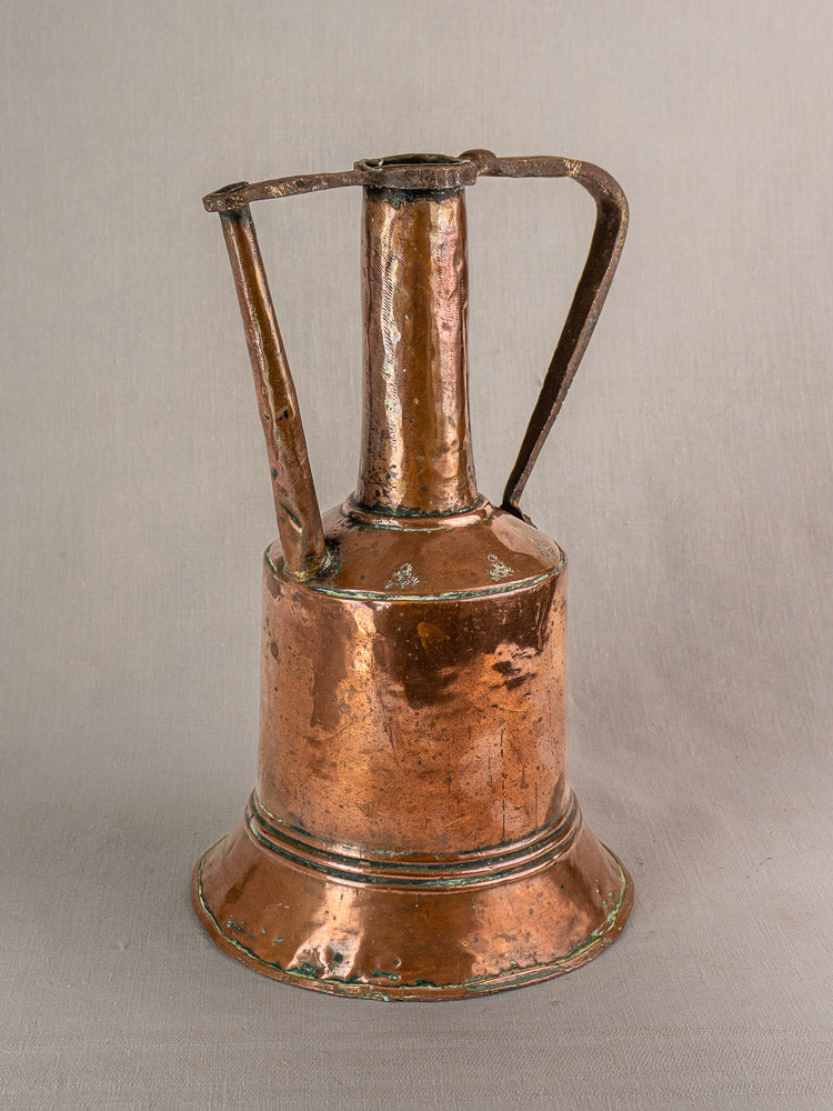 Antique French copper water jug with iron handle, wide base, narrow neck, and hand-hammered patina.