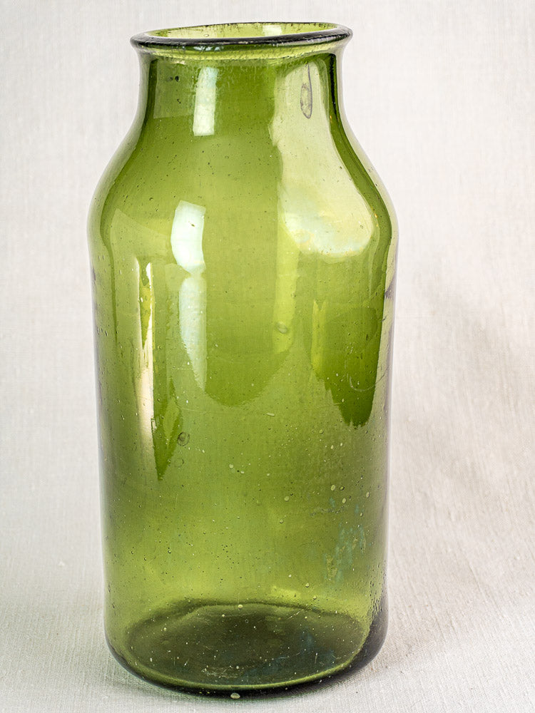 Antique French cornichon jar, late 18th-century hand blown green glass bottle with tall cylindrical form and narrow neck.