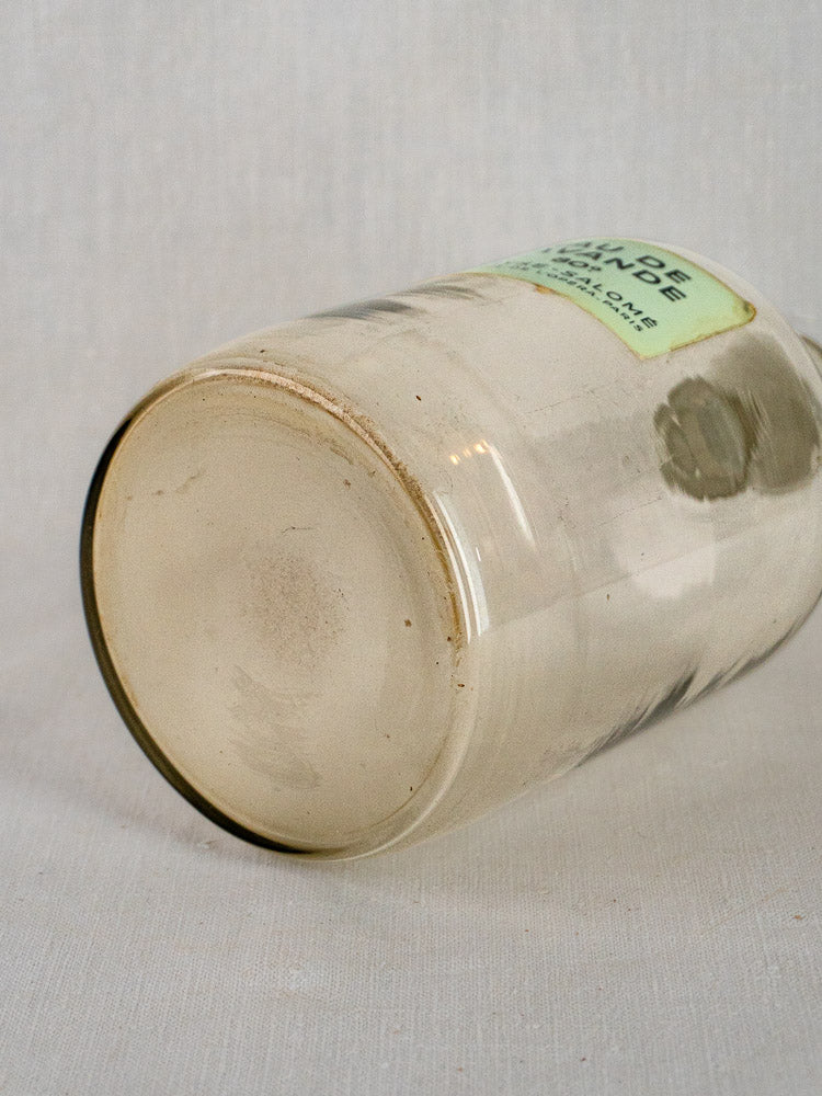Coryse-Salomé French perfume bottle resting on its side, rounded base and green label visible.