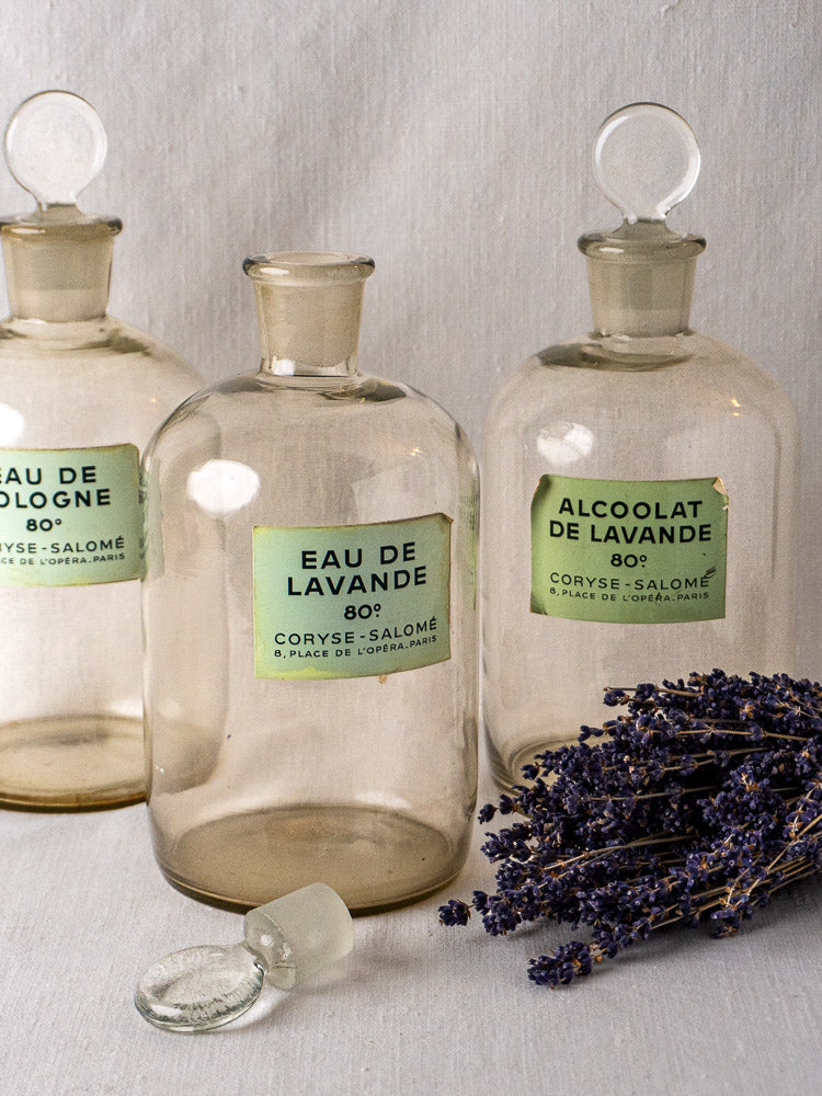 Set of five Coryse-Salomé French glass perfume bottles with vintage labels and dried lavender.