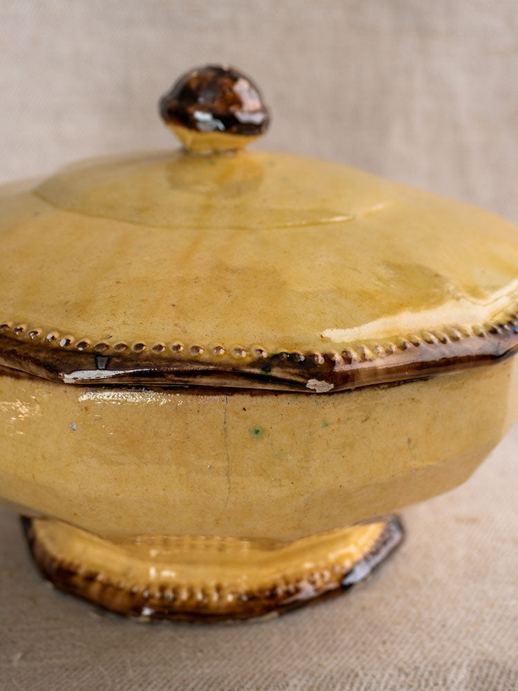 Antique French Vallauris Beretta et Cie mustard-glazed pottery table service, three-piece set with brown accents on fabric.