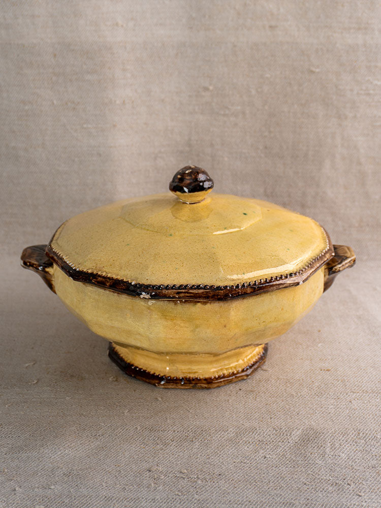 Antique French Vallauris Beretta et Cie mustard-glazed pottery soup tureen set with lid and brown trim on beige fabric.