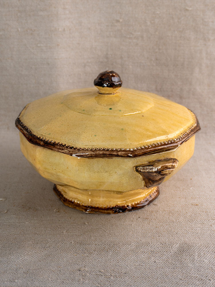 Vallauris Beretta et Cie antique French pottery set with mustard-glazed lidded dish, brown accents; beige fabric background.