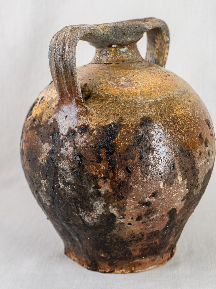 Antique French 18th-century Orjol terracotta jar with two handles and mottled brown rustic finish.