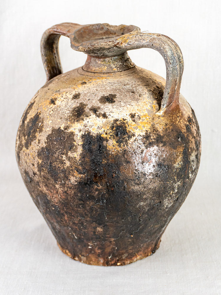 18th-century French terracotta Orjol pouring jar with two handles, narrow neck, and aged patina.