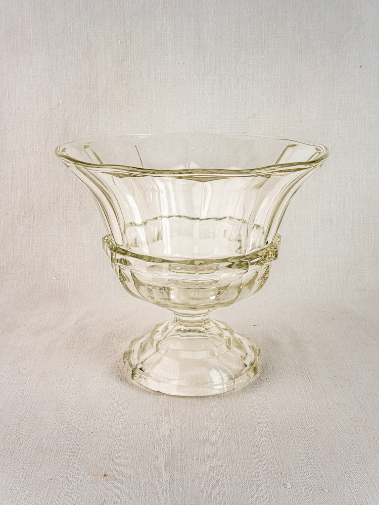 Antique French cristallin glass Coupe Médicis compotier with flared rim and decorative bands, on textured fabric background.