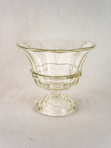 Antique French cristallin glass Coupe Médicis compotier with flared rim and decorative bands, on textured fabric background.