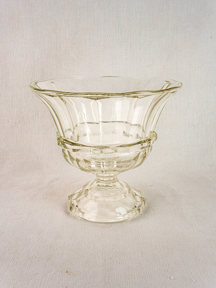 Mid 19th century French clear glass coupe with wide rim and short pedestal on light fabric.
