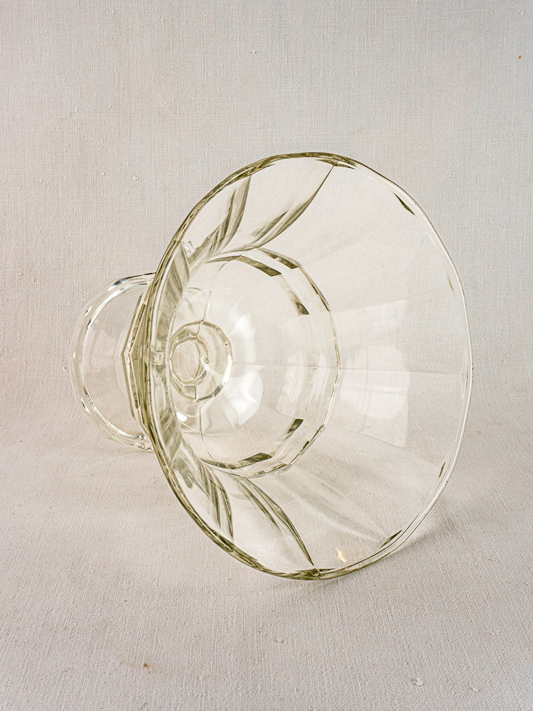 Antique French glass Coupe Médicis compotier, mid 19th century, on light textured surface.