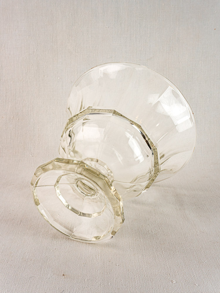 Antique French cristallin glass Coupe Médicis compotier with flared rim and faceted body on gray.