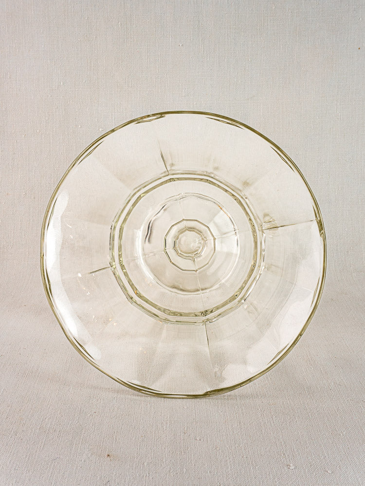 Antique French Glass Coupe Médicis compotier with geometric, faceted pattern on neutral textured background.