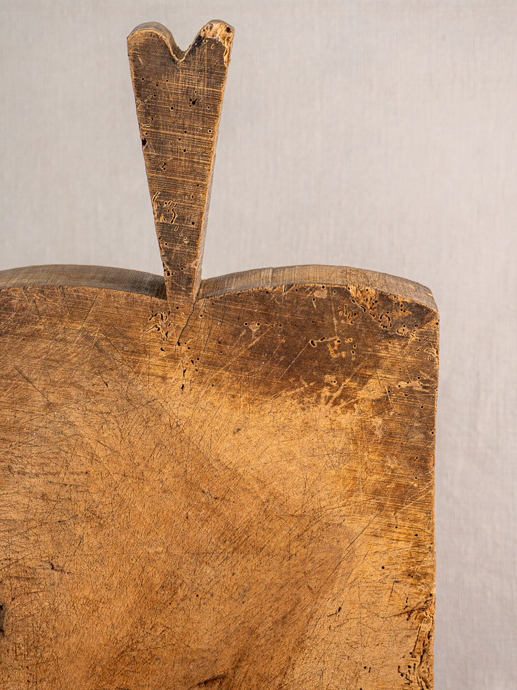 Antique French cutting board with heart-shaped handle and aged patina, circa 1880s, primitive farmhouse style.