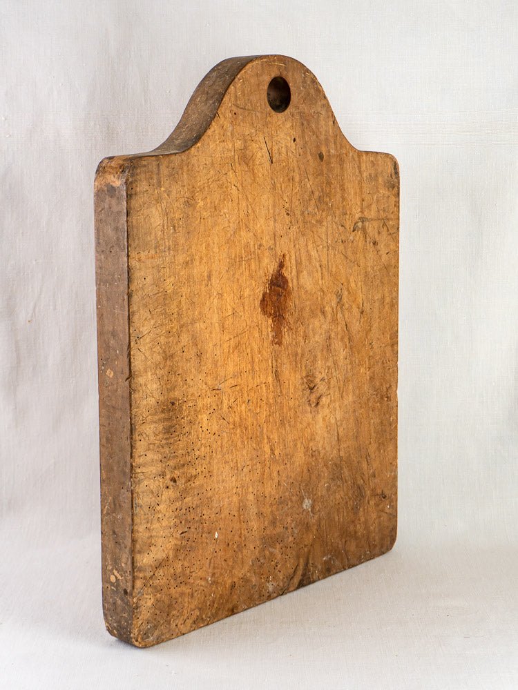 Antique French beech chopping board, circa 1900, with thick rectangular shape and worn knife marks.