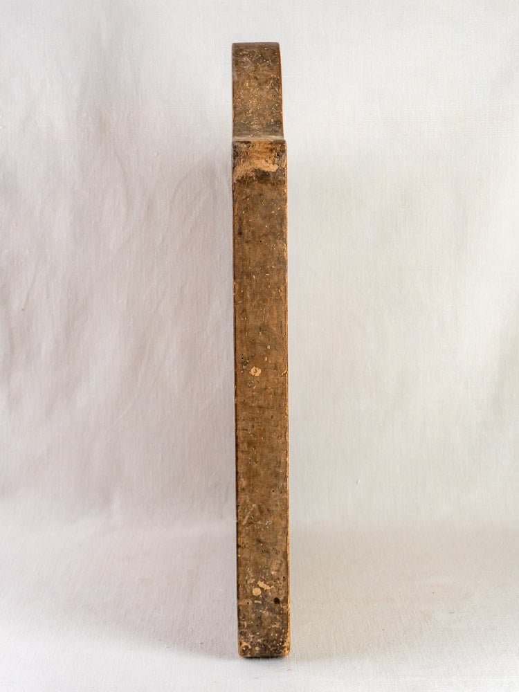 Antique French beech chopping board, circa 1900, with weathered brown tones on a light surface.