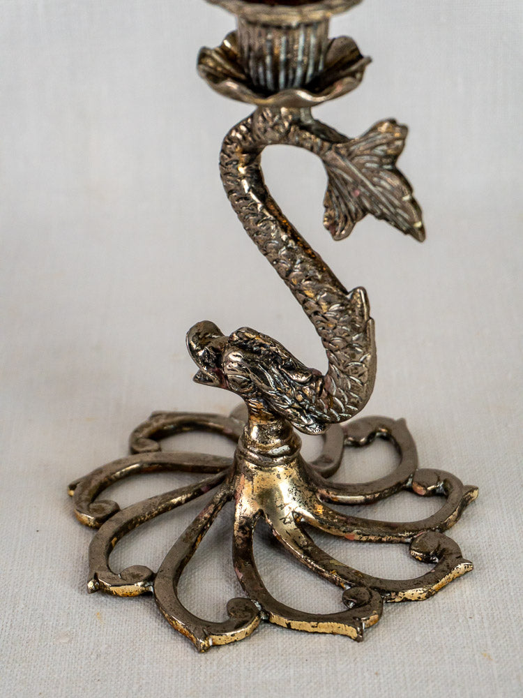 Antique French Dolphin silvered metal candlestick holder with sculpted dolphin stem and ornate wave base.