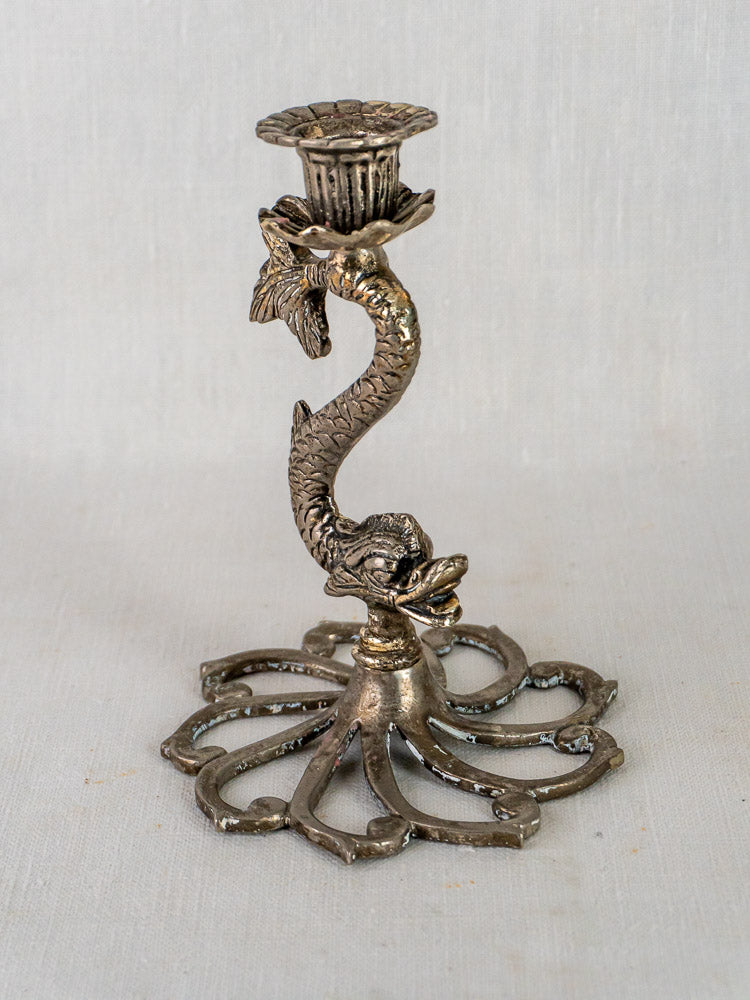 Pair of antique silvered French dolphin candlesticks with ornate fish motifs and openwork bases.