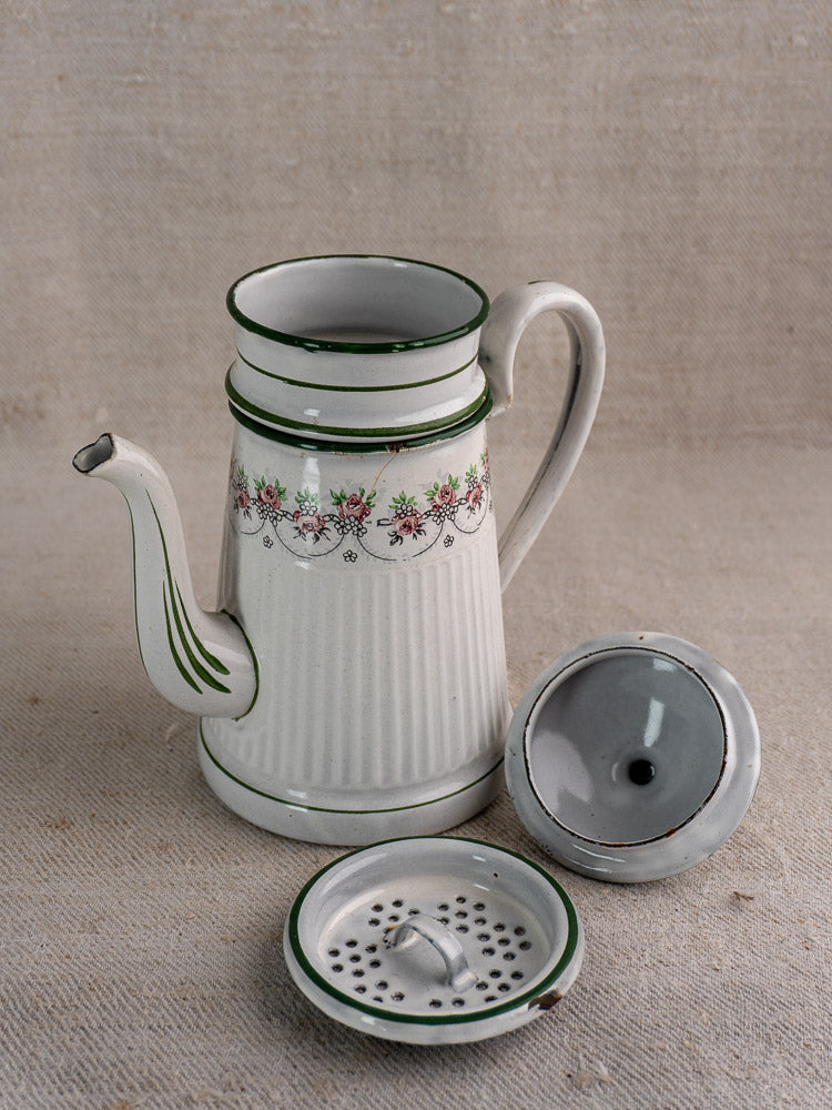 Antique French enamel coffee pot by B.B. Frères, green lines and floral band, lid and filter shown on fabric.